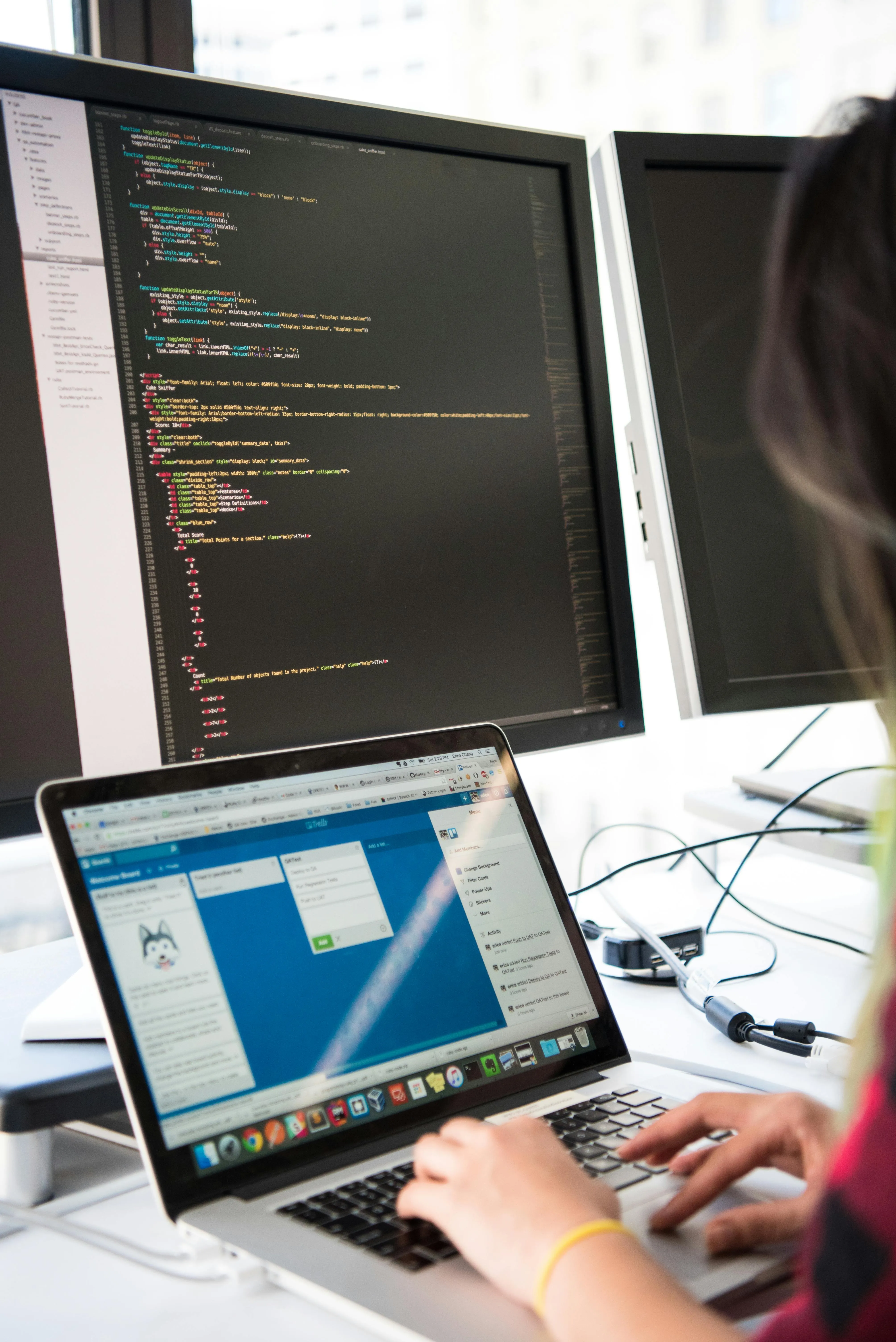 Code on computer screen with a woman